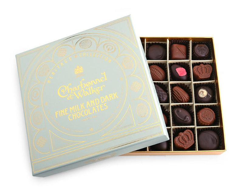 A box of Charbonnel et Walker fine chocolates, with some milk and dark chocolate pieces visible inside the open box, displayed on a white background.