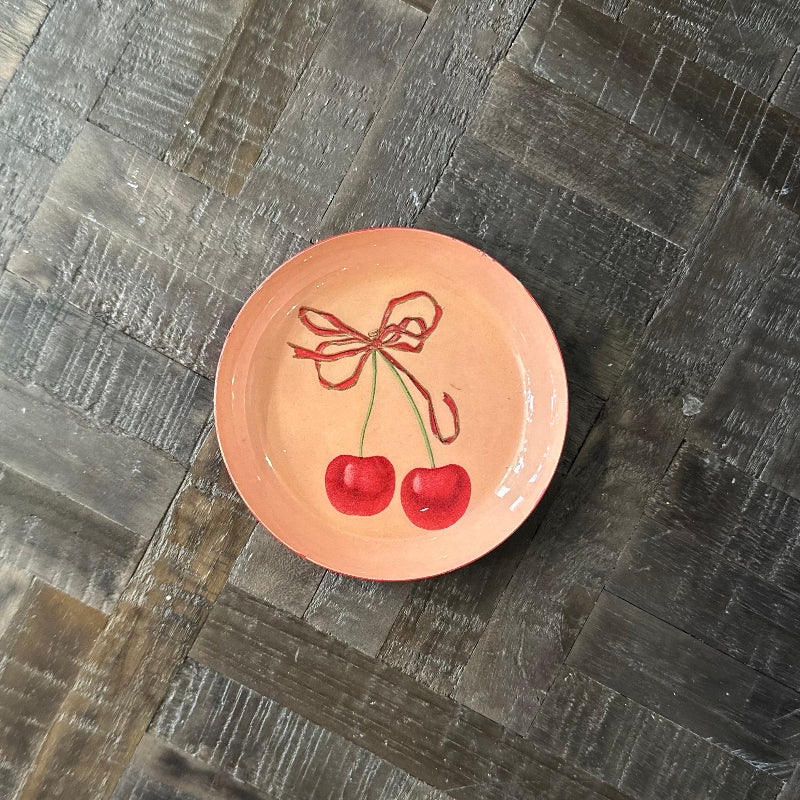Ceramic plate with cherry design on a wooden surface