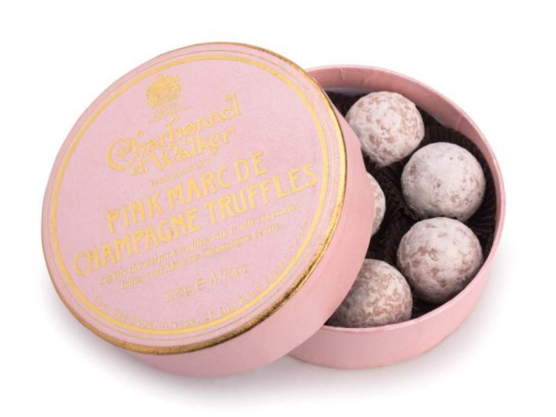 A box of Pink Marc de Champagne chocolate truffles with the brand name visible, indicating luxury and suitability for vegetarians.