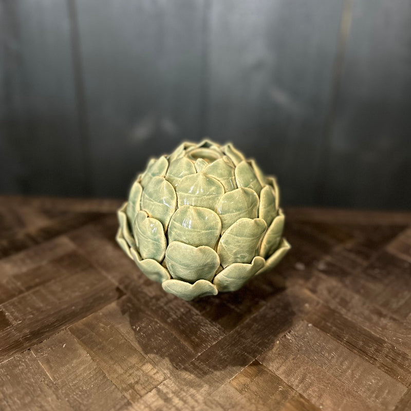 Artichoke on a wooden surface with a dark background