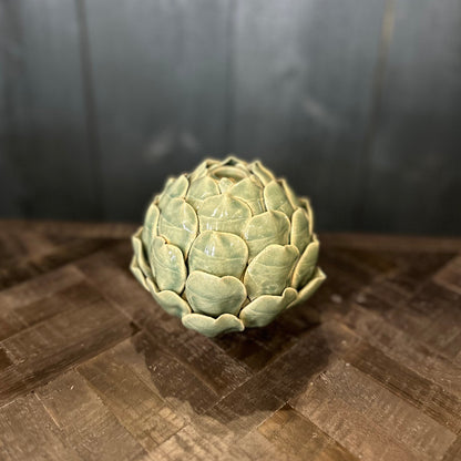 Artichoke on a wooden surface with a dark background
