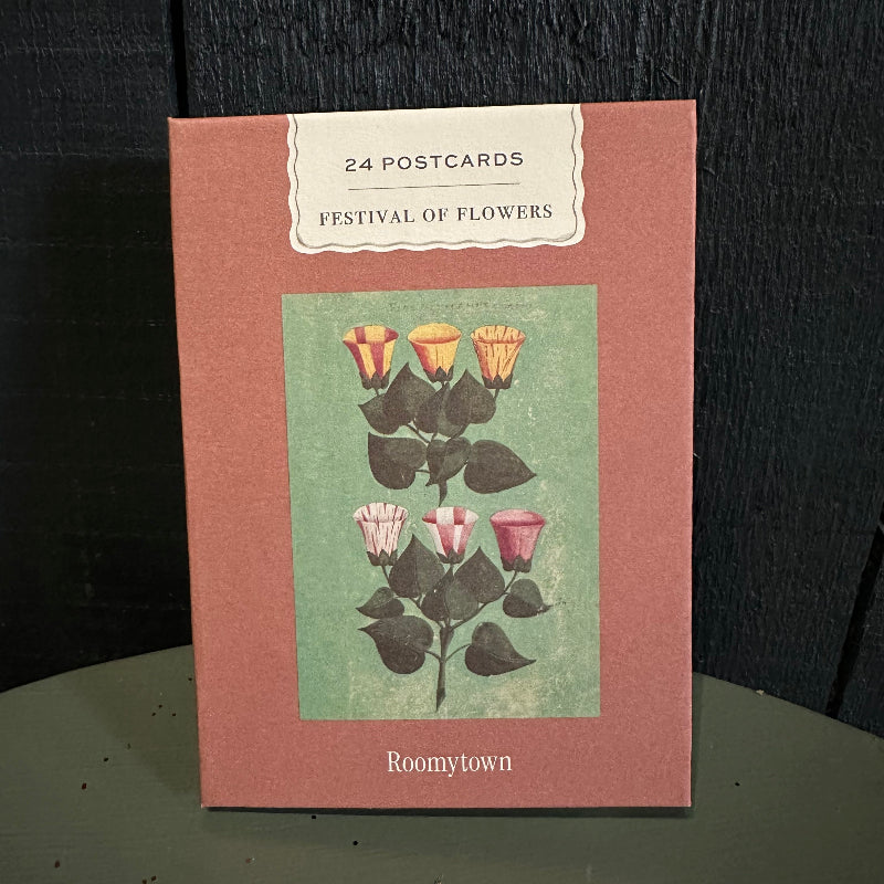 Pack of postcards with floral design on a dark surface