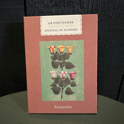 Pack of postcards with floral design on a dark surface