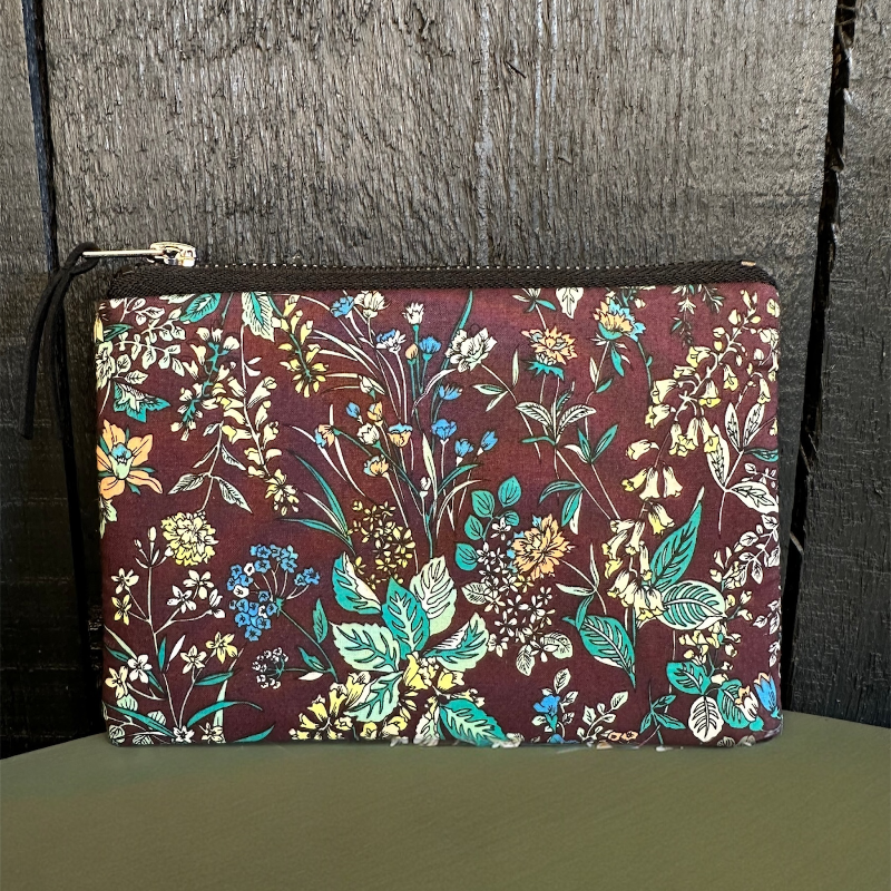 Floral-patterned pouch on a wooden surface