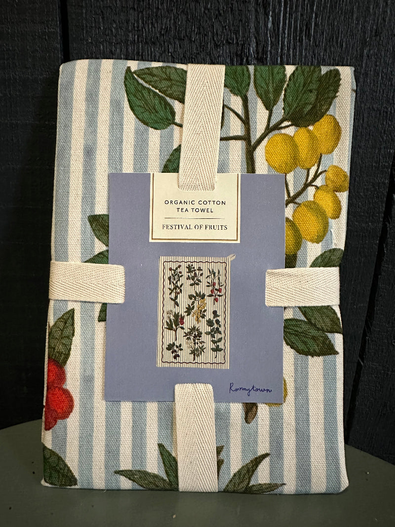 Tea towel with botanical design and striped pattern on a dark surface