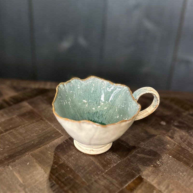 Ceramic cup with textured surface on a wooden surface