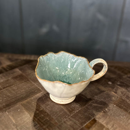Ceramic cup with textured surface on a wooden surface