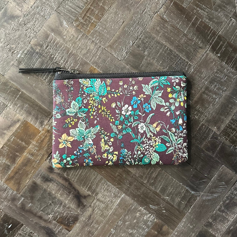 Floral-patterned wallet on a wooden surface