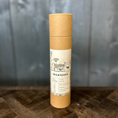 Kraft paper tube with a label on a wooden surface and gray background