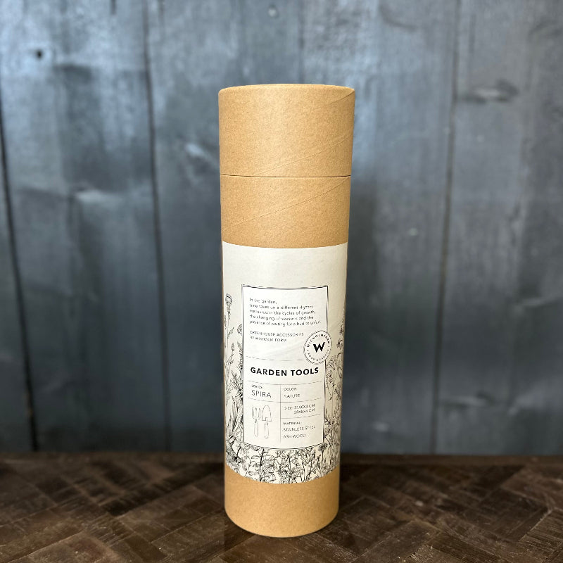 Kraft paper tube with a label on a wooden surface and gray background