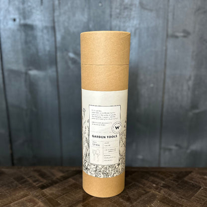 Kraft paper tube with a label on a wooden surface and gray background