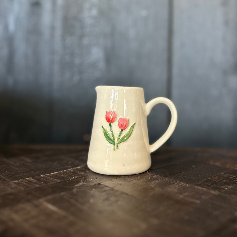 Ceramic mug with floral design on a wooden surface