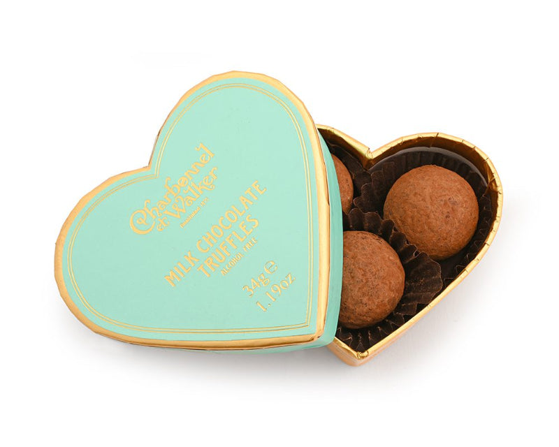 Heart-shaped chocolate box with truffles on a white background