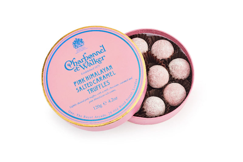 Pink Himalayan salted caramel truffles in a Charbonnel et Walker tin on a white background